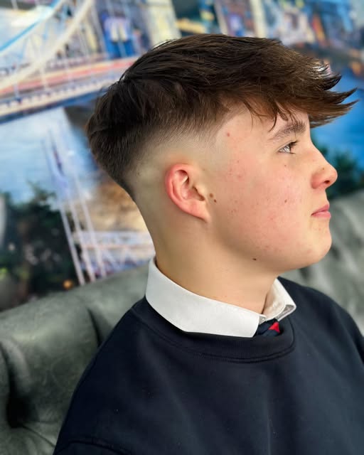 Side view of a close skin fade and swept top