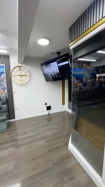 Interior of The Room Barber with black and gold details and wood-effect flooring